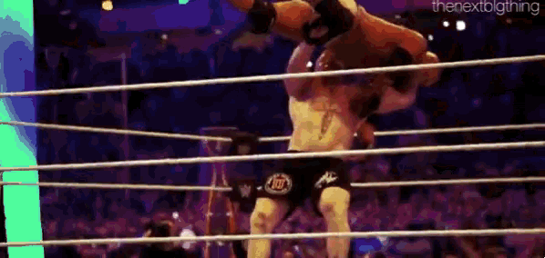 two men are wrestling in a ring with a crowd watching and the words the next big thing on the bottom