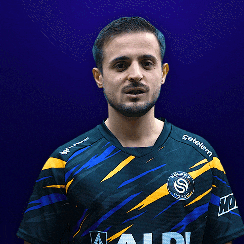 a man wearing a blue and yellow solari shirt
