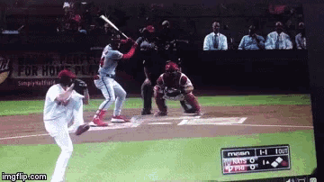 a baseball game is being played in front of a sign for home plate
