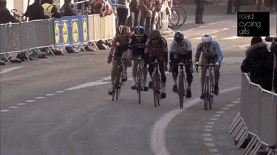 a group of cyclists are racing down a road with a lidl banner behind them