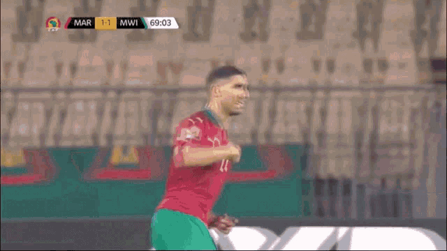 a soccer player with the number 7 on his jersey is running on the field