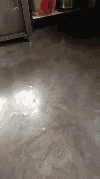 a close up of a concrete floor with a red sticker on it that says ' chinese '