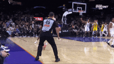 a basketball referee with the number 45 on his back