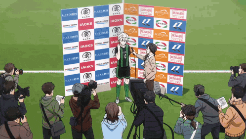 a soccer player is being interviewed by a group of reporters in front of a banner that says iaoks