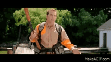 a man is holding a shotgun in front of a house and says makeagif.com at the bottom