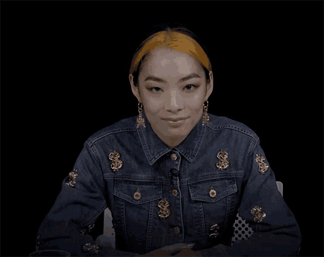 a woman wearing a denim jacket says guilty b*tch