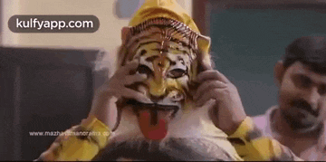 a man is wearing a tiger mask and a yellow hat .