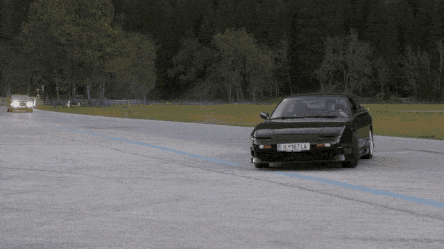 a black car with a license plate that says lm987 la
