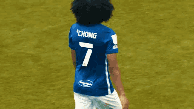 a soccer player wearing a blue jersey with the name chong on the back