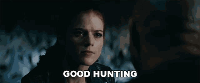a woman in a leather jacket is looking at a man and the words good hunting are above her
