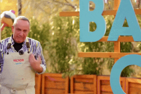 a man wearing an apron with victor on it