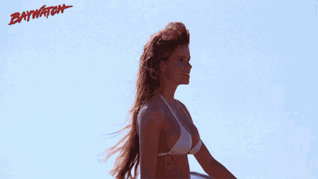 a man and a woman are running on a beach with the word baywatch written on the bottom