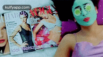 a woman with a green mask on her face is laying on a bed