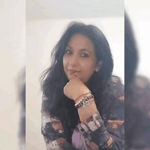 a woman with a piercing in her lip and a bracelet on her wrist