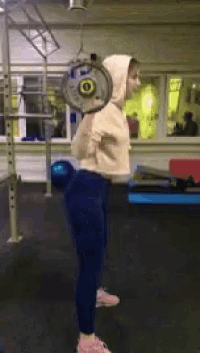 a woman squatting with a barbell on her back