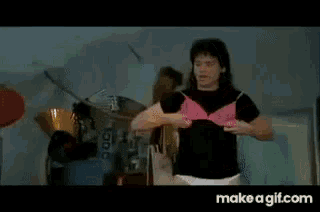 a woman in a pink bra and white underwear is standing in a room with make a gif.com in the corner .