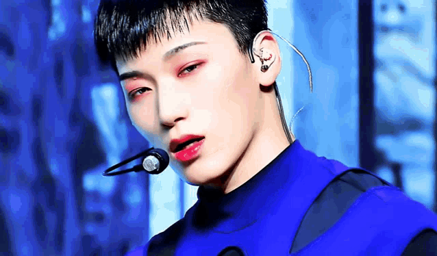 a close up of a man wearing a microphone and earphones .