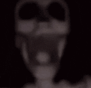 a blurry picture of a skeleton with a hole in its head .