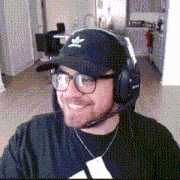 a man wearing headphones and a hat with the adidas logo on it