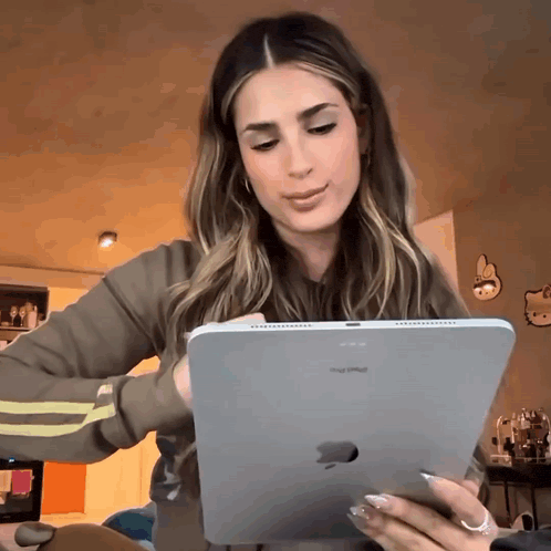 a woman is using an apple ipad in a living room