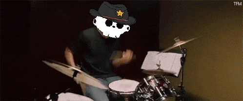 a man wearing a cowboy hat is playing the drums