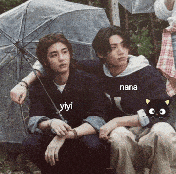 a couple of young men sitting under an umbrella with nana written on the bottom right