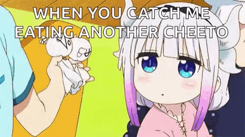 a girl with horns is eating another cheeto while a man holds a piece of paper in front of her .