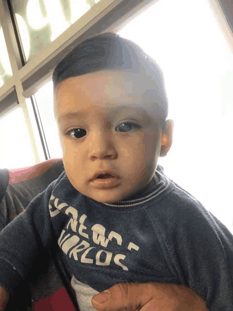 a baby wearing a sweater that says ' yale on worlds ' on it
