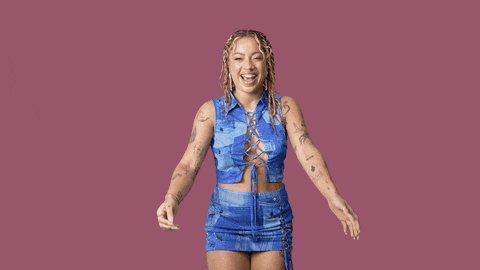 a woman with tattoos on her arms is wearing a blue top and a blue skirt