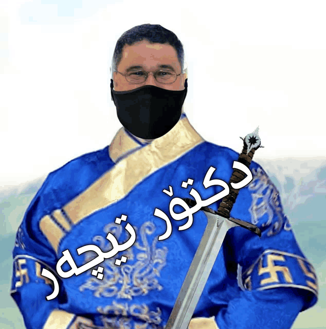 a man wearing a mask and a blue robe holds a sword with a foreign language written on it