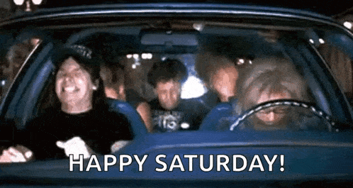 a group of people are sitting in a car and laughing .