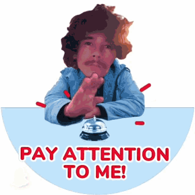 a man is sitting at a table with a bell and the words pay attention to me