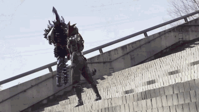 a person with a sword on their back is walking down stairs