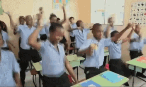 a group of students are dancing in a classroom .