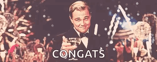 a man in a tuxedo is holding a trumpet in front of a crowd that says congrats on the bottom