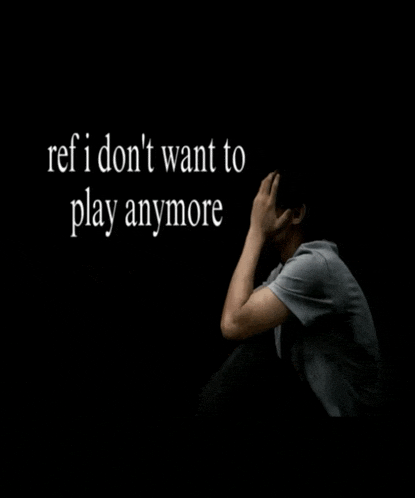 a man sits in a dark room with the words ref i don 't want to play anymore behind him