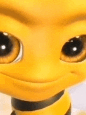 a close up of a yellow cartoon character with big eyes and a smile on its face .