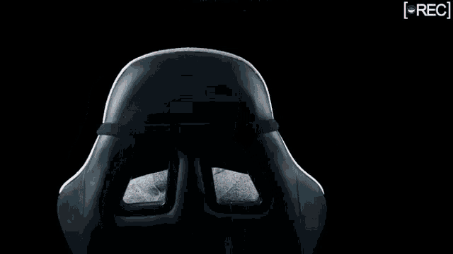 a man with a beard and a hat is sitting in a chair .