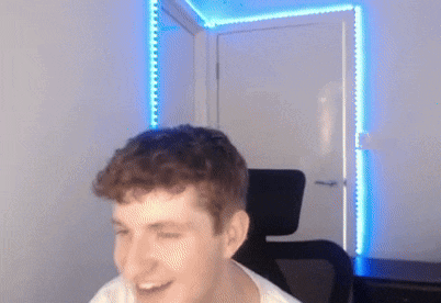 a man is sitting in a chair with his eyes closed in front of a door with blue lights on it .