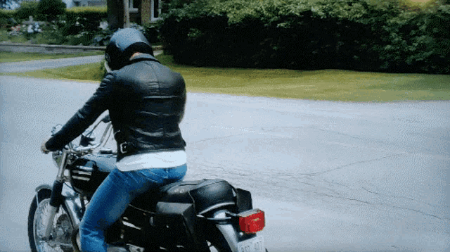 a man is riding a motorcycle with a license plate that says ao-407
