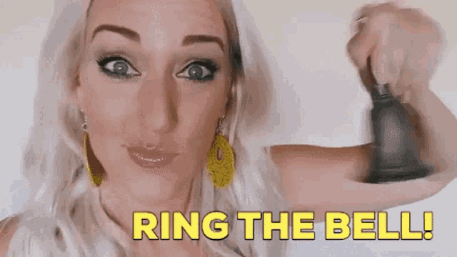 a woman is holding a bell and saying ring the bell .