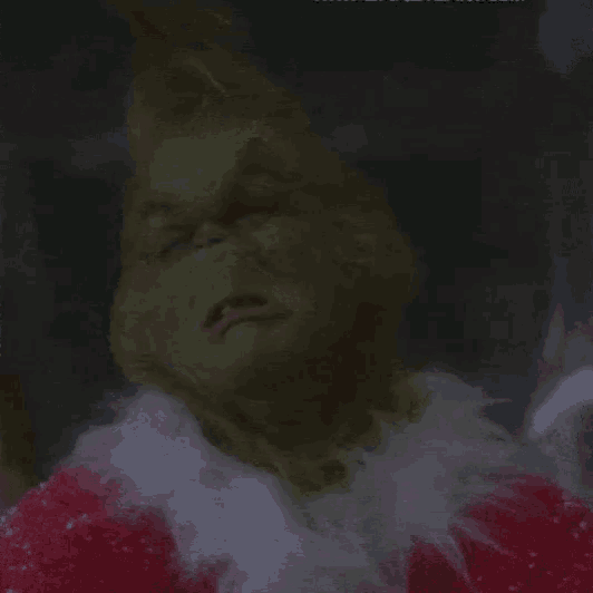 a close up of the grinch 's face with his mouth open