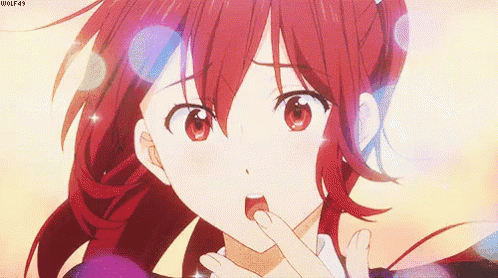 a girl with red hair and red eyes is covering her mouth with her hands .