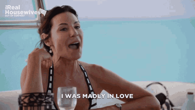 a woman says i was madly in love while holding a glass of water