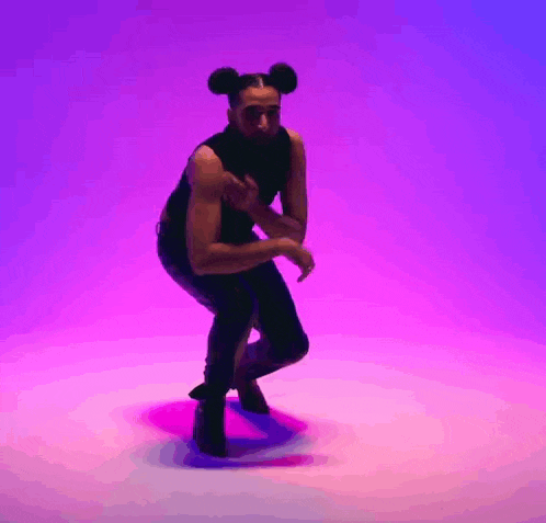 a man with a beard and mickey mouse ears is dancing in front of a purple and pink background .