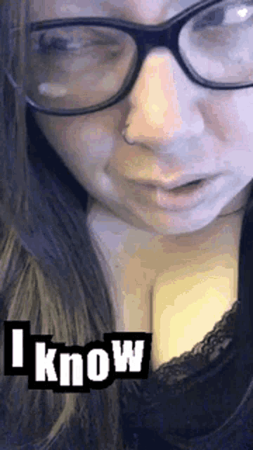 a close up of a woman wearing glasses and a nose ring