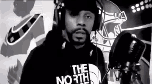 a black and white photo of a man wearing a north face shirt