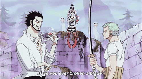two men are standing next to each other and one of them is holding a sword and the other is holding a wine glass .
