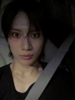 a close up of a woman 's face with a seat belt around her neck
