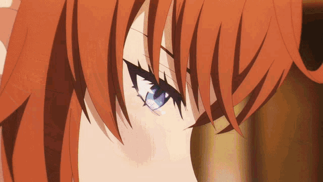 a close up of a person 's face with red hair and blue eyes